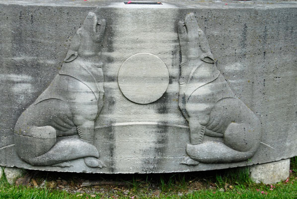 wolves feature in stone bas-relief