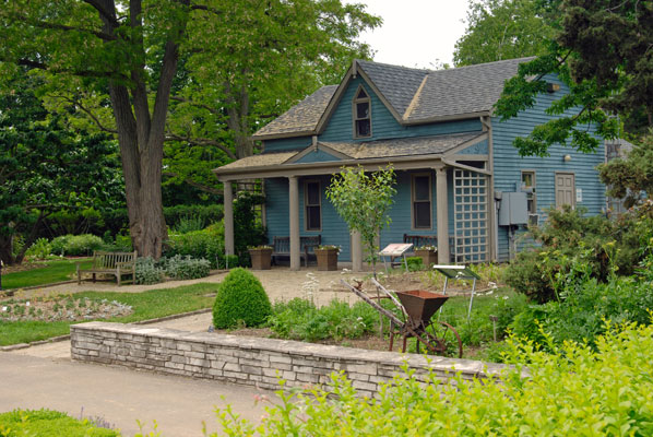 a blue cottage in the Laking Garden