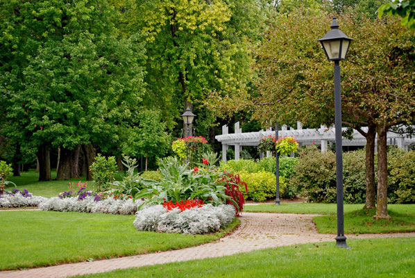 brick pathways bordered by beds of annuals